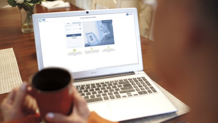 Patient actively participating in care by accessing health records with a laptop