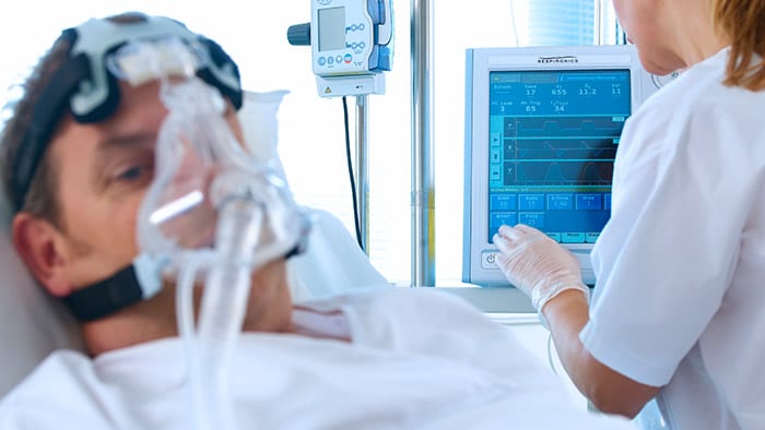 A patient with a ventilator mask on