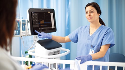 A clinician operating VX850 ventilator