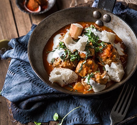 Roasted chicken meatballs with spiced tomato sauce, basil, yogurt & bread