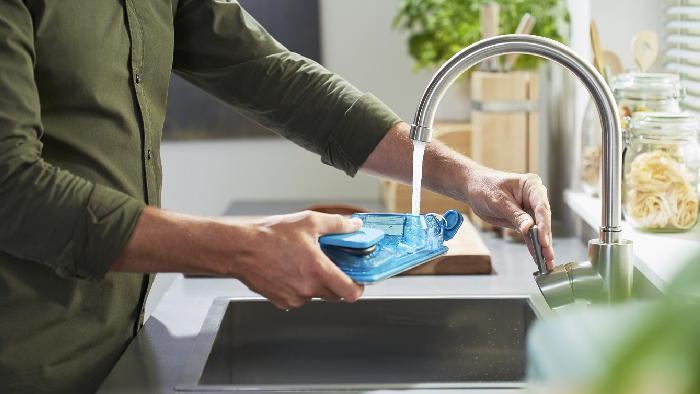 man cleaning vacuum cleaner