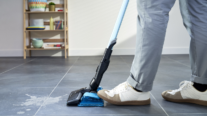 man cleaning on surface with vacuum cleaner