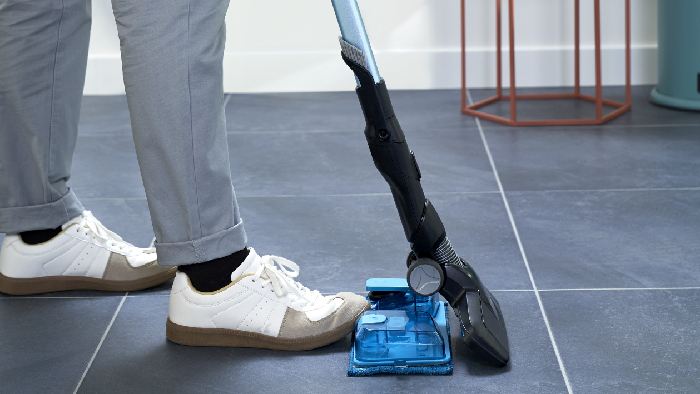 man using vacuum cleaner on the floor