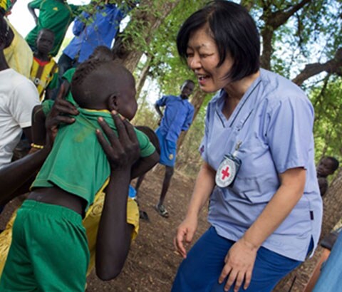 Red Cross personnel with child