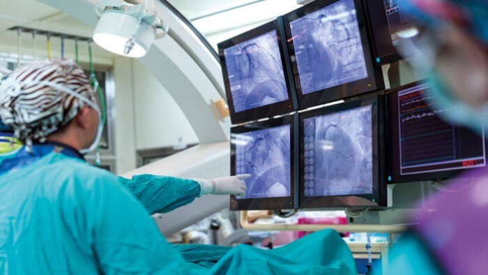 Surgeons looking at scans of a patient